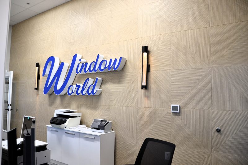 Office area with the Window World logo mounted on a woodgrain feature wall