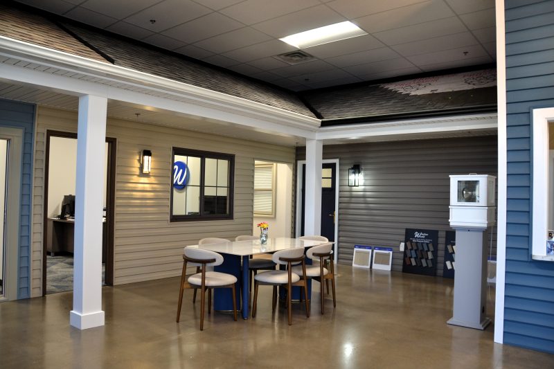 Consultation seating beneath a full-scale porch display in the showroom