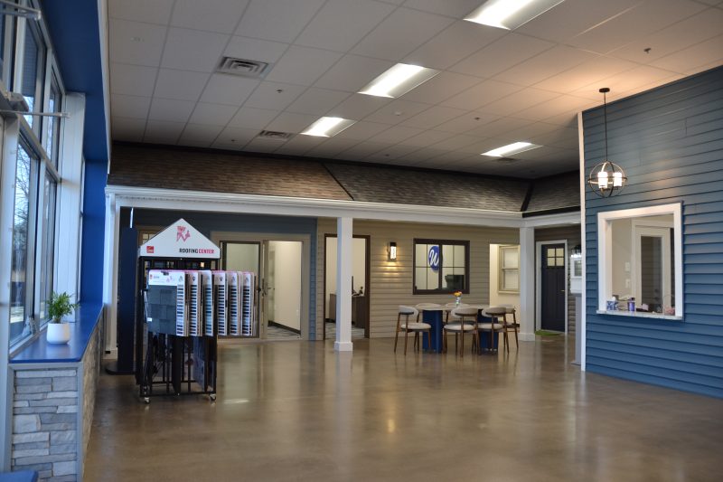 Wide view of the showroom floor, with product displays along a polished concrete aisle